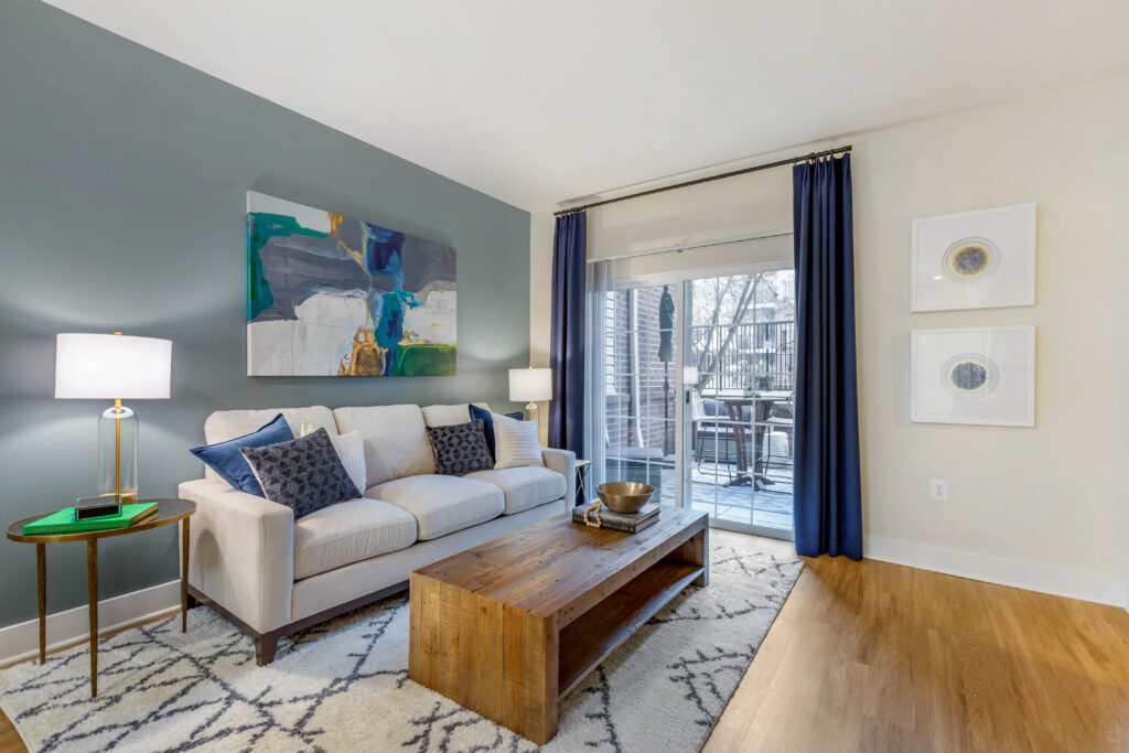Bell Arlington Ridge apartment living room layout with a couch and coffee table next to an outdoor patio.
